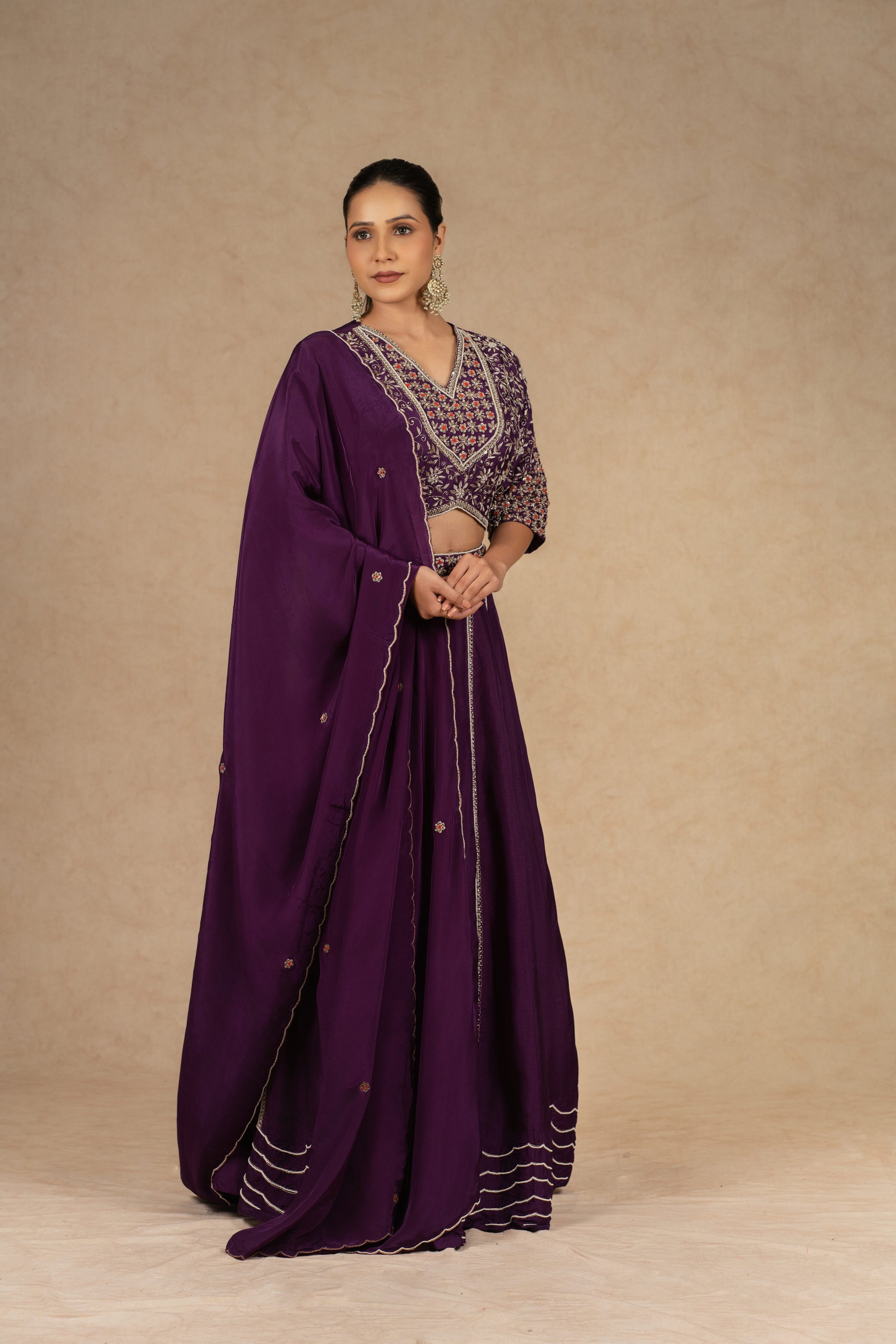 Purple silk kalidar lehenga choli with dupatta featuring intricate dabka, sequins, thread, and pearl embellishments, ideal for festive and wedding occasions.