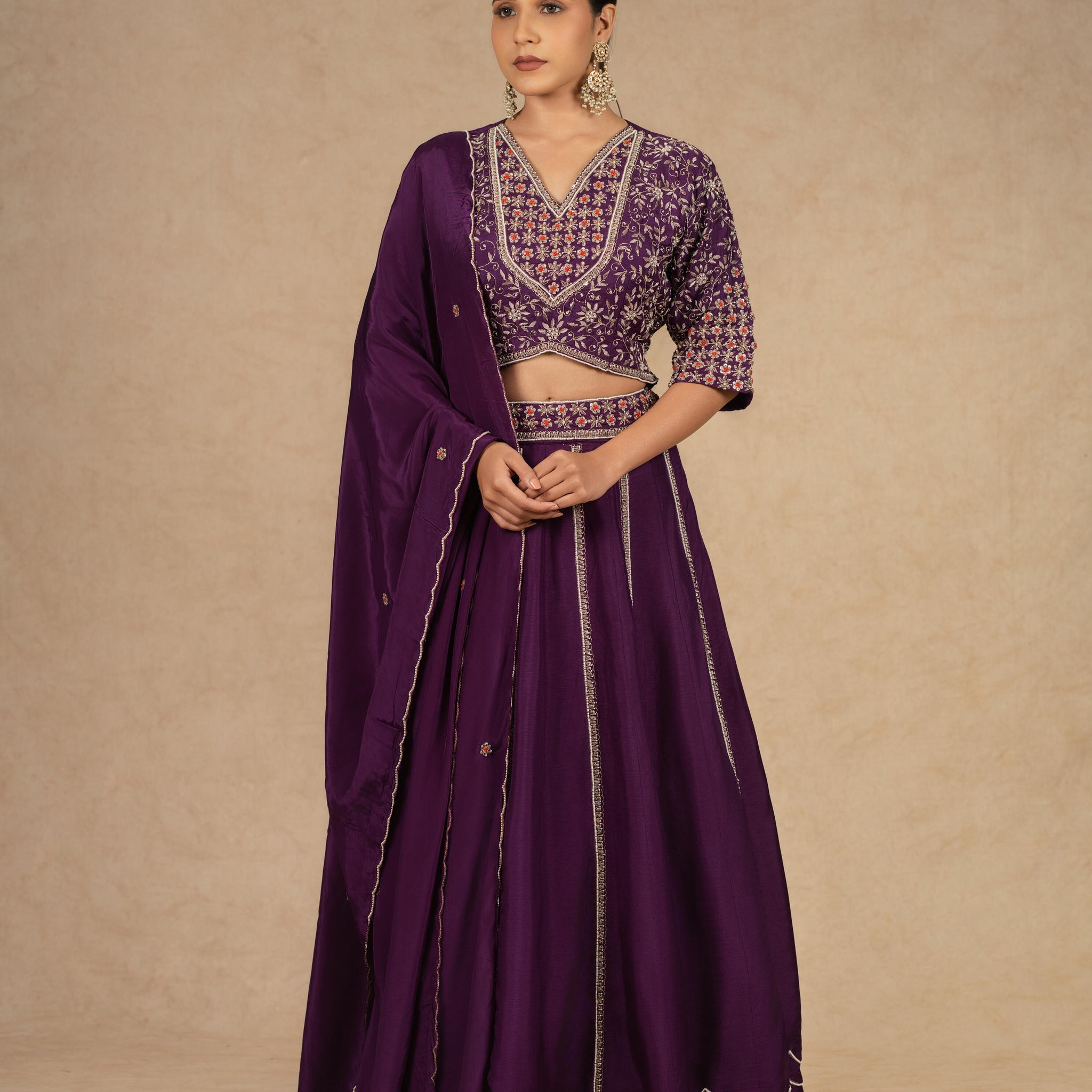 Purple silk kalidar lehenga choli with dupatta featuring intricate dabka, sequins, thread, and pearl embellishments, ideal for festive and wedding occasions.