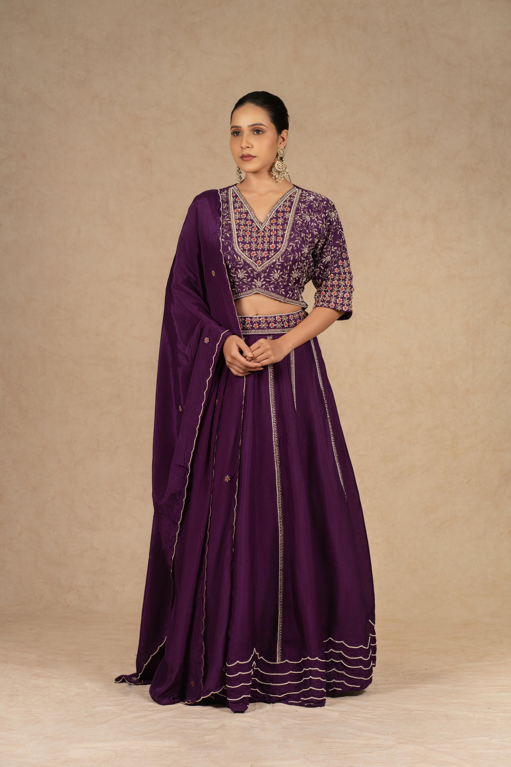 Purple silk kalidar lehenga choli with dupatta featuring intricate dabka, sequins, thread, and pearl embellishments, ideal for festive and wedding occasions.