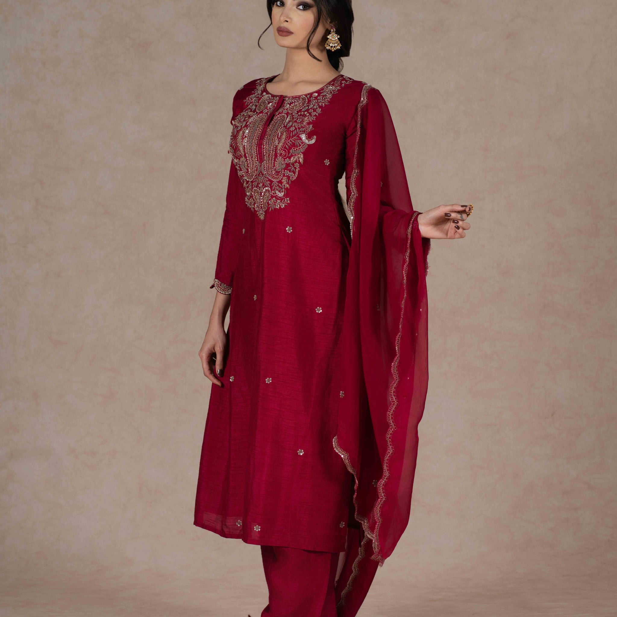 Deep red kurta and pant set with intricate zardozi embroidery, paired with an organza dupatta—perfect for festive occasions, pujas, and celebrations