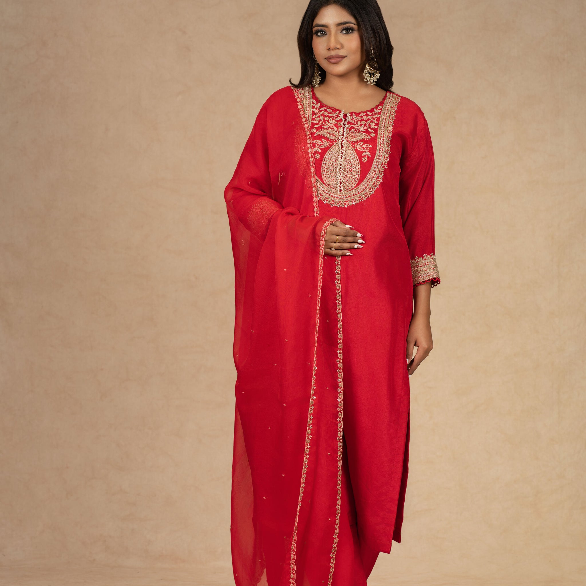 Red silk straight suit with intricate gold embroidery, featuring a matching pair of pants and an embellished organza dupatta – perfect for festive and formal occasions.