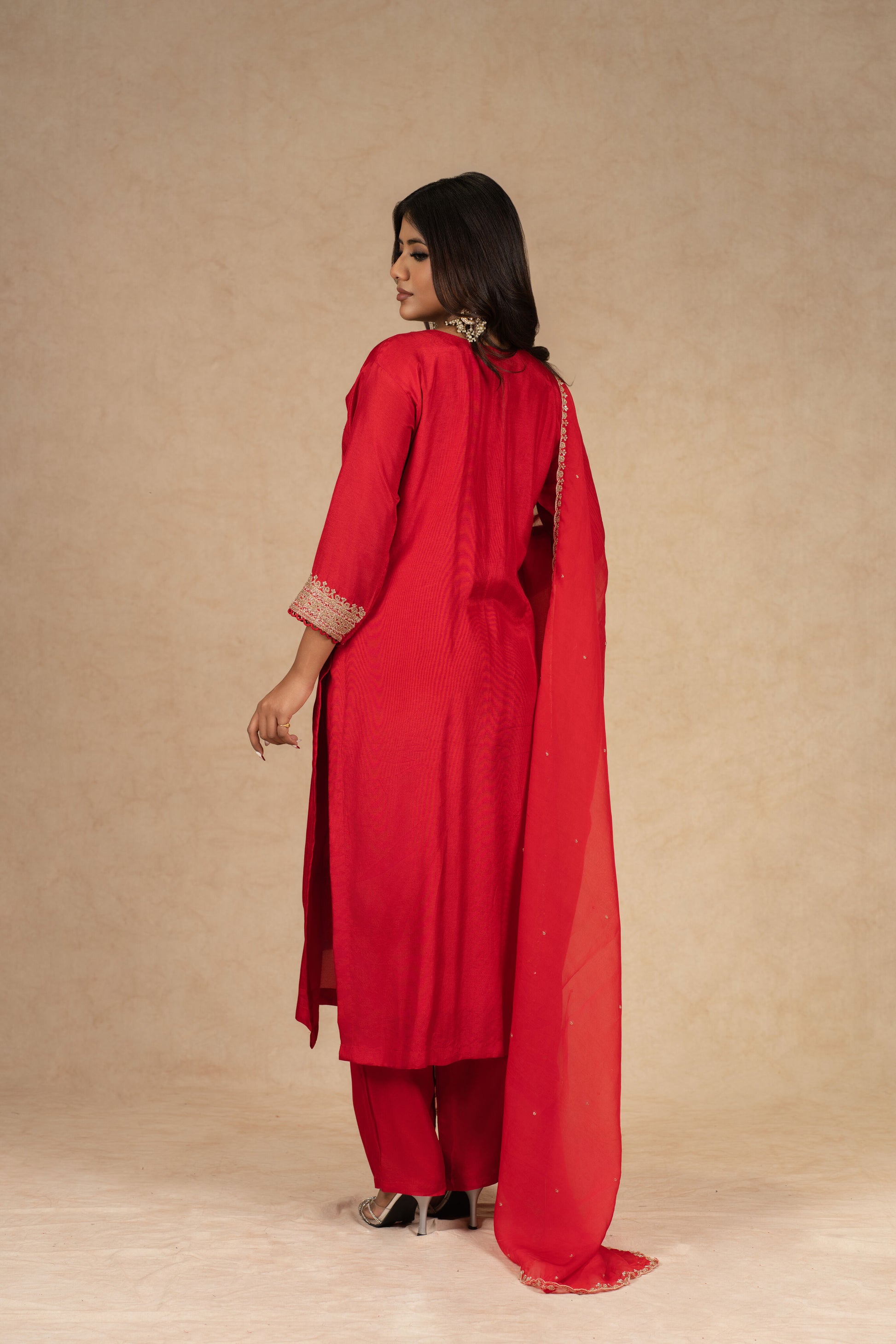 Red silk straight suit with intricate gold embroidery, featuring a matching pair of pants and an embellished organza dupatta – perfect for festive and formal occasions.