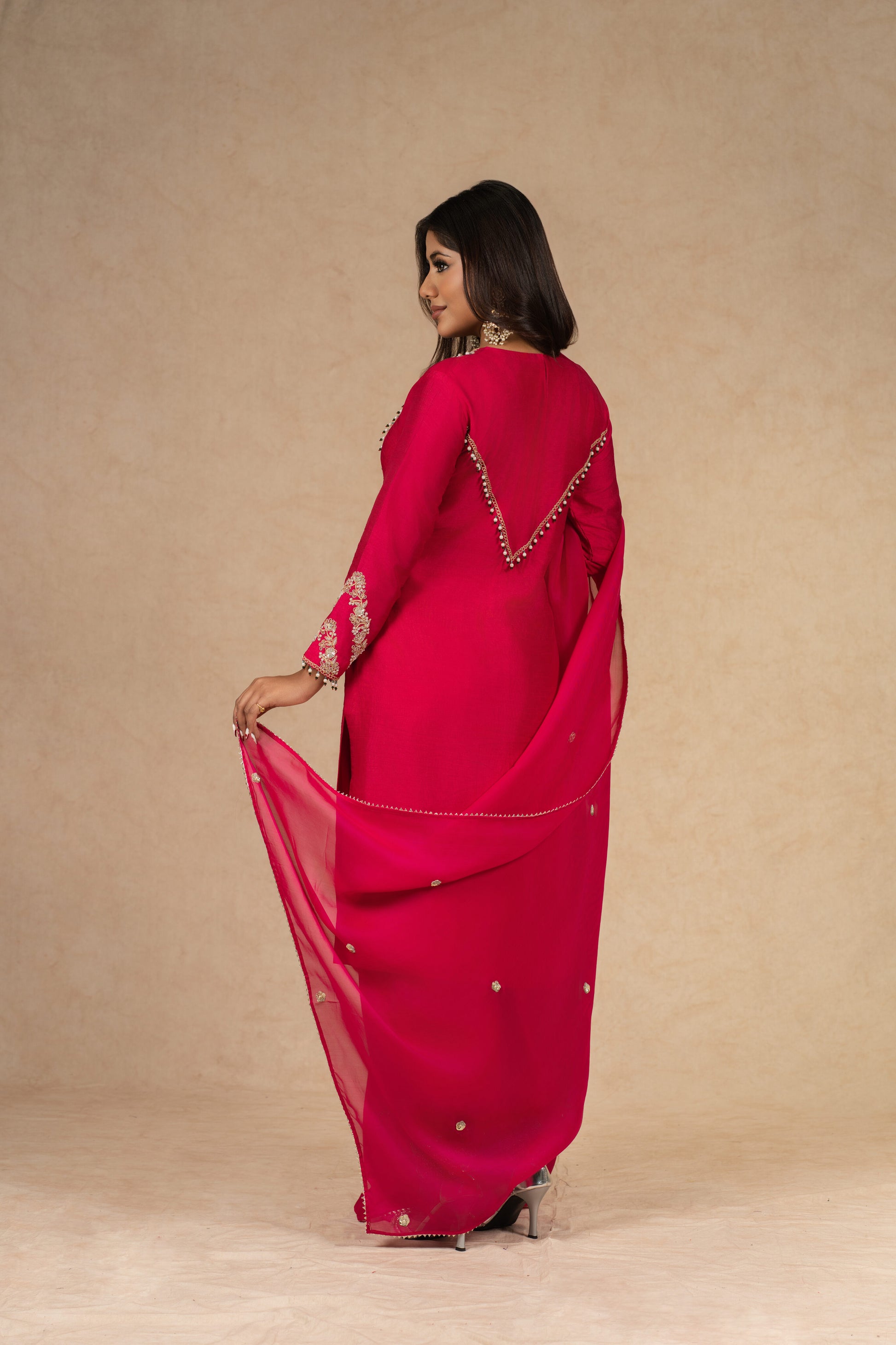 Model showcasing the back design of the Red Straight Silk Suit, featuring an embroidered sheer dupatta with elegant detailing.