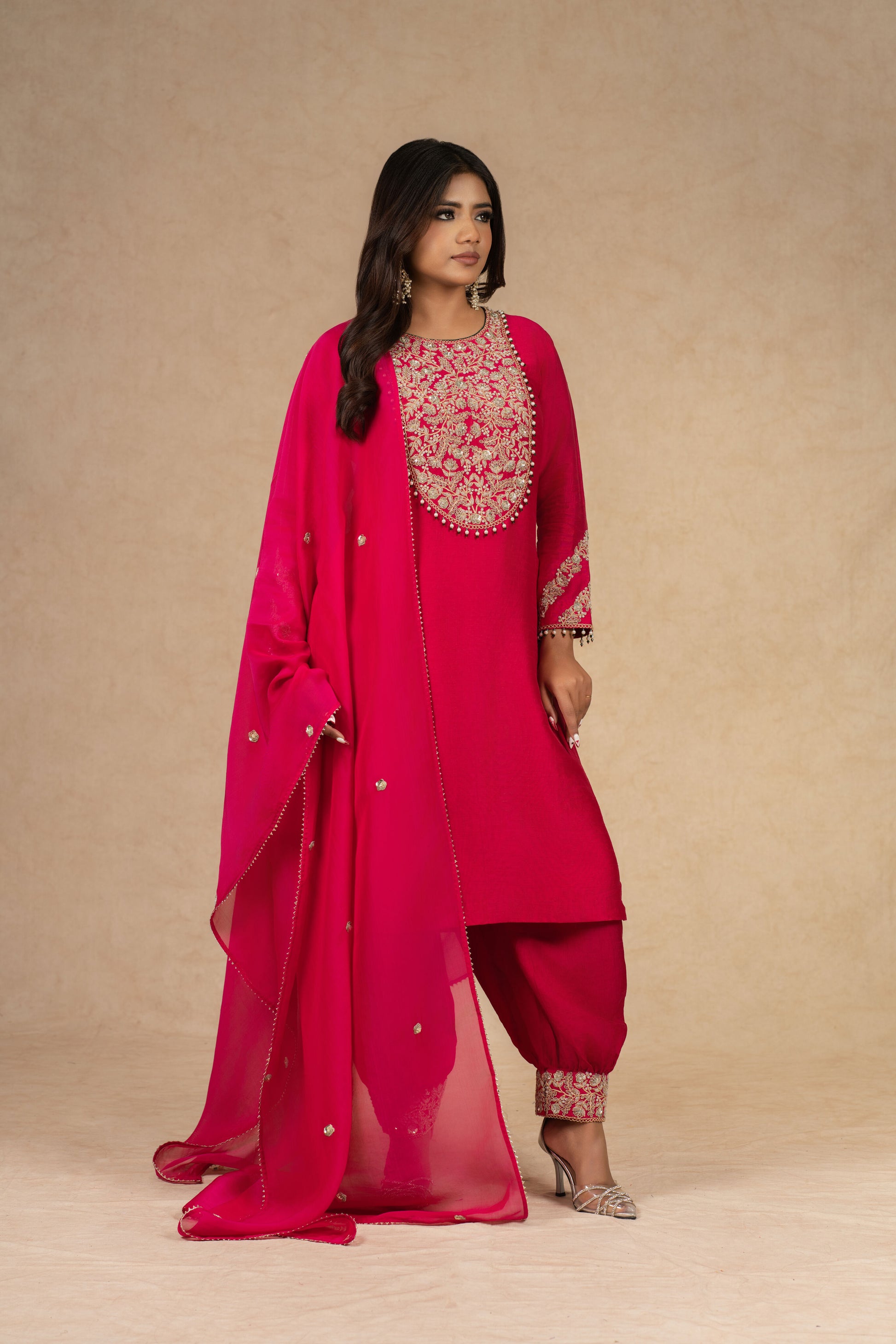 A regal look featuring a Red Straight Silk Suit, adorned with delicate embellishments, paired with stylish ankle-length pants.