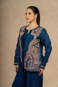 Close-up of the royal blue Indo Western jacket, highlighting detailed embroidery and sheer organza fabric.