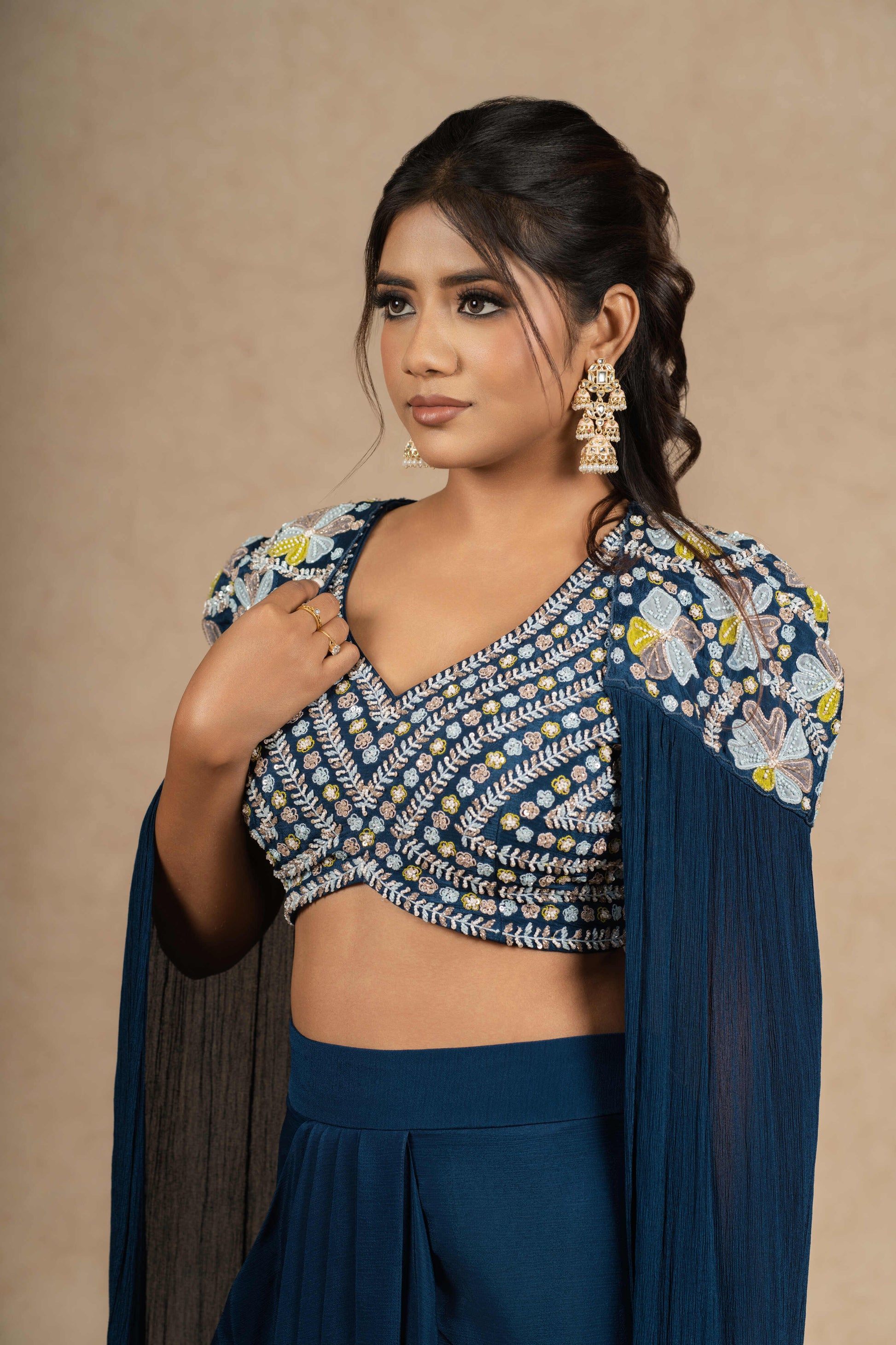 A close-up view of the Royal Blue Indo-Western outfit, showcasing detailed embellishments on the blouse and delicate embroidery on the cape.