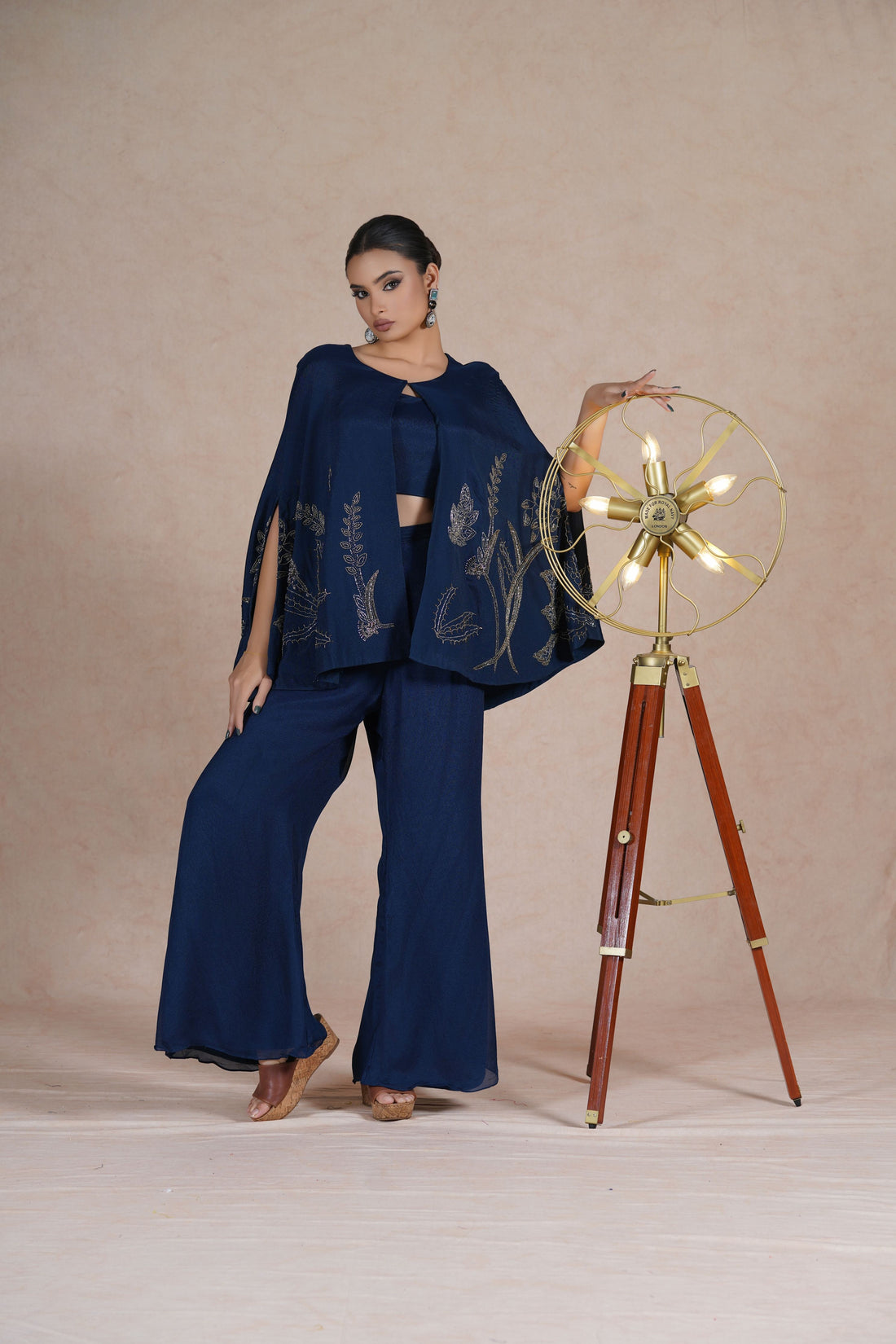 Model standing confidently in a Royal Blue Indo Western Cape Set, featuring pearl and cutdana embroidery.