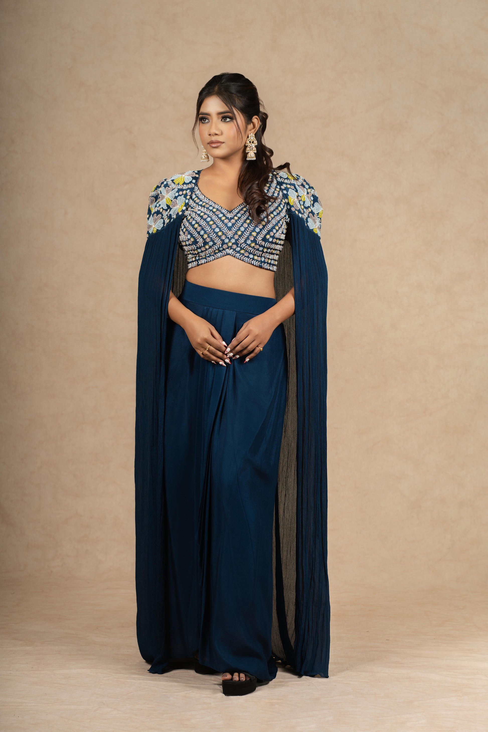 Model elegantly standing in a Royal Blue Indo-Western ensemble, emphasizing the regal drape and intricate craftsmanship.