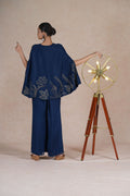 Model delicately draping the embroidered cape of the Royal Blue Indo Western Set, showcasing its craftsmanship.