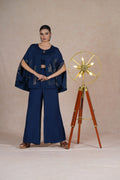 Model standing confidently in a Royal Blue Indo Western Cape Set, featuring pearl and cutdana embroidery.