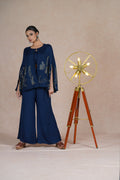 Model giving a soft side glance while wearing the Royal Blue Indo Western Set, emphasizing the flowy silhouette.