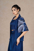 Royal blue embroidered jacket with cape sleeves, sweetheart neckline bustier, and pleated floor-length skirt. Elegant festive or formal ensemble.