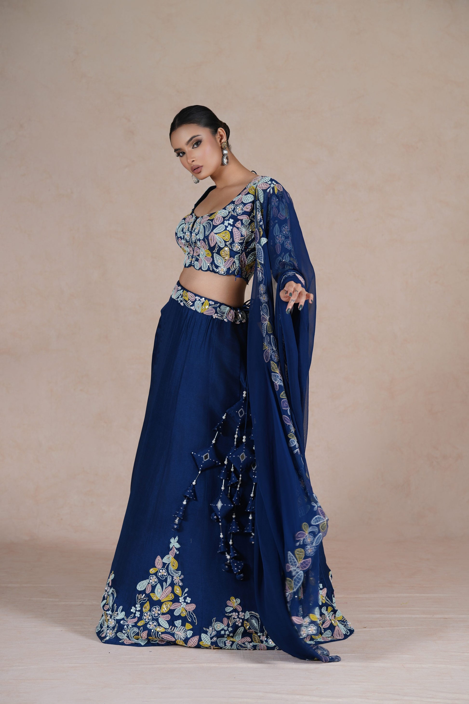 Dramatic pose highlighting the beauty of the Royal Blue Lehenga Choli paired with an organza dupatta.