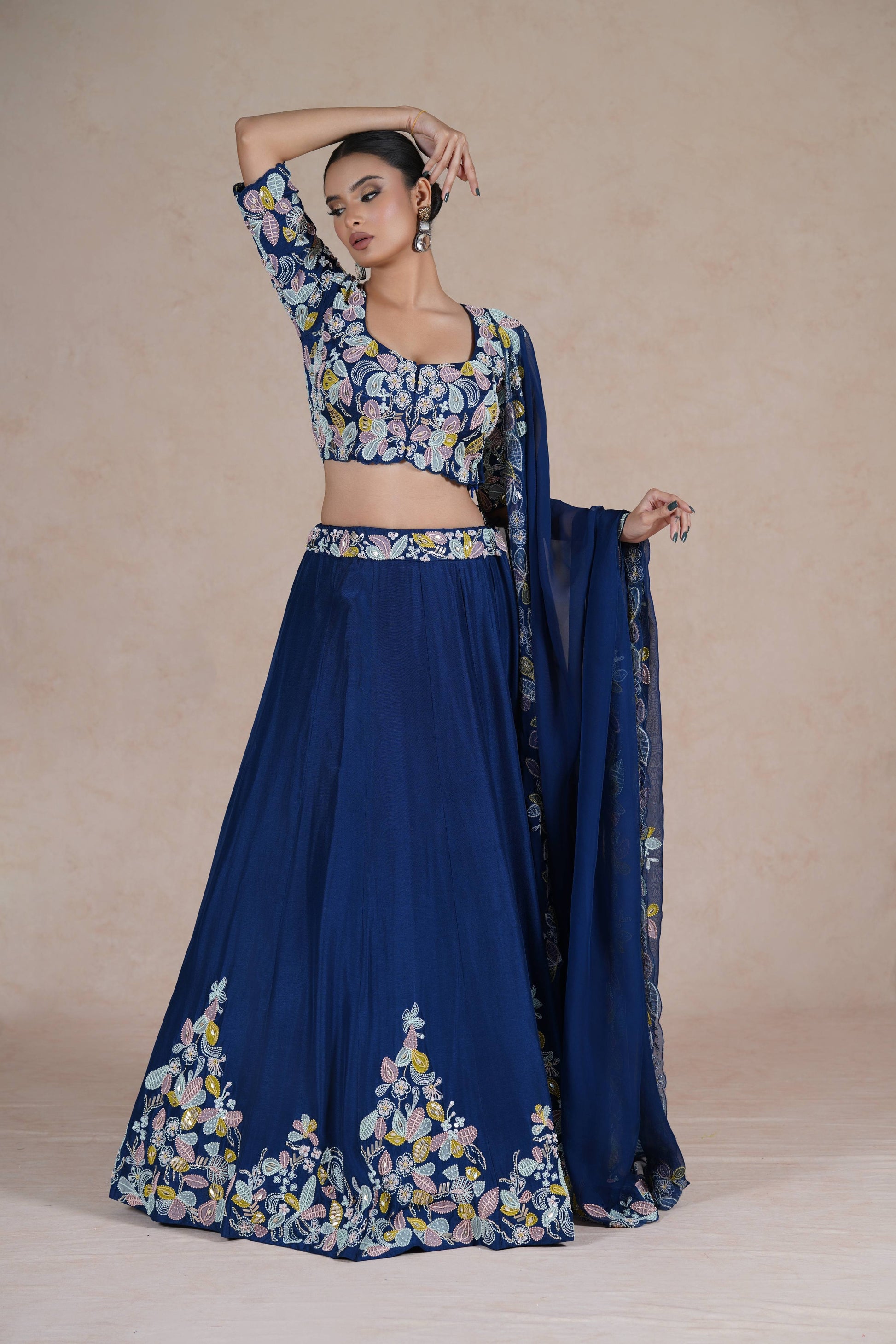 Model showcasing the Royal Blue Lehenga Choli in a graceful stance with intricate embroidery details.
