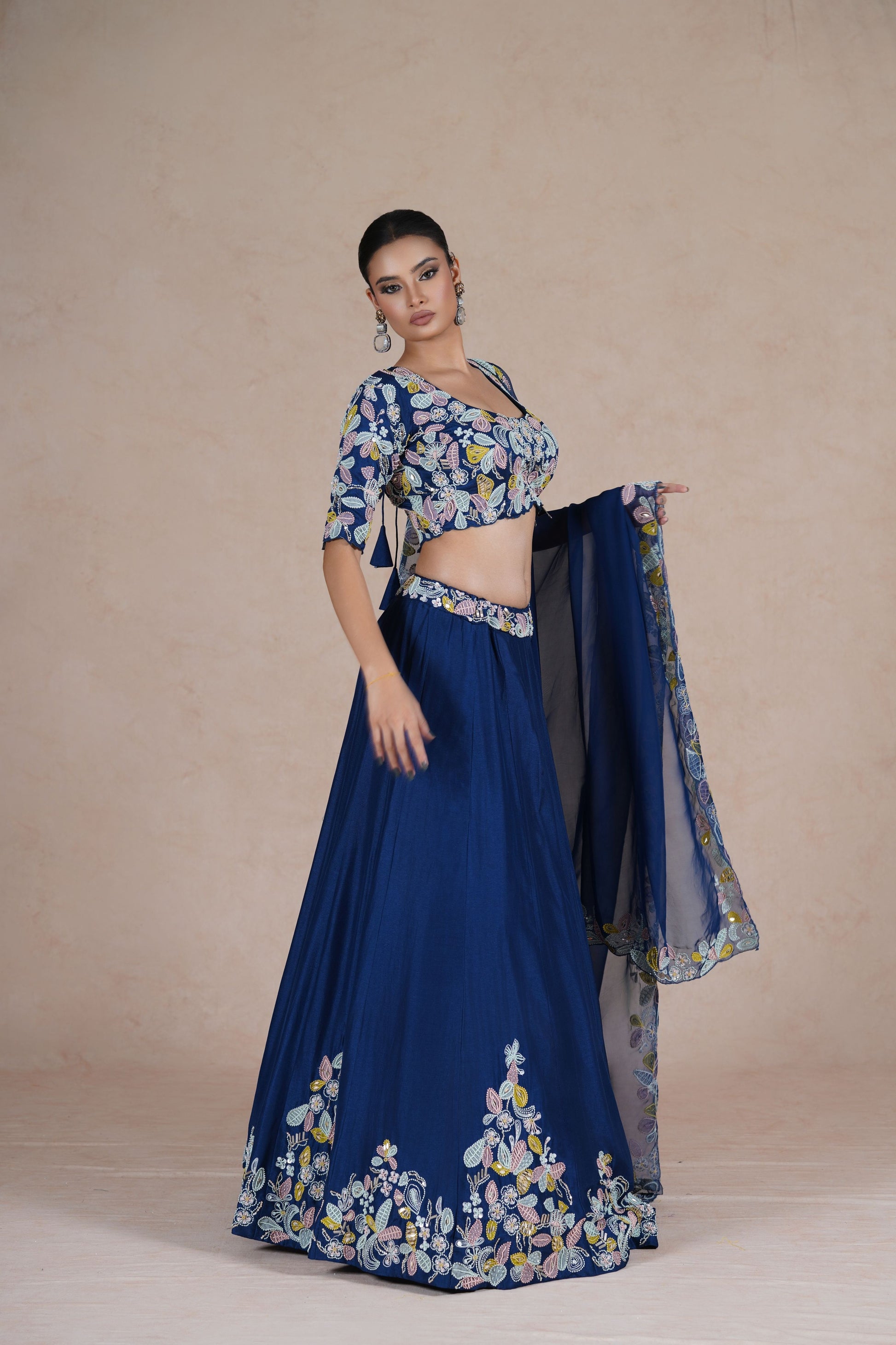 Stylish angle showcasing the flowy silhouette of the Royal Blue Lehenga Choli with elegant embellishments.
