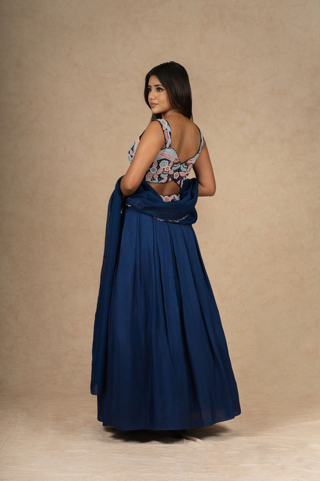 Royal blue lehenga choli with intricate embroidery, paired with a flowy organza dupatta.