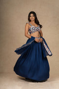 Twirling shot of the royal blue lehenga choli, highlighting its flowy silhouette and organza dupatta.