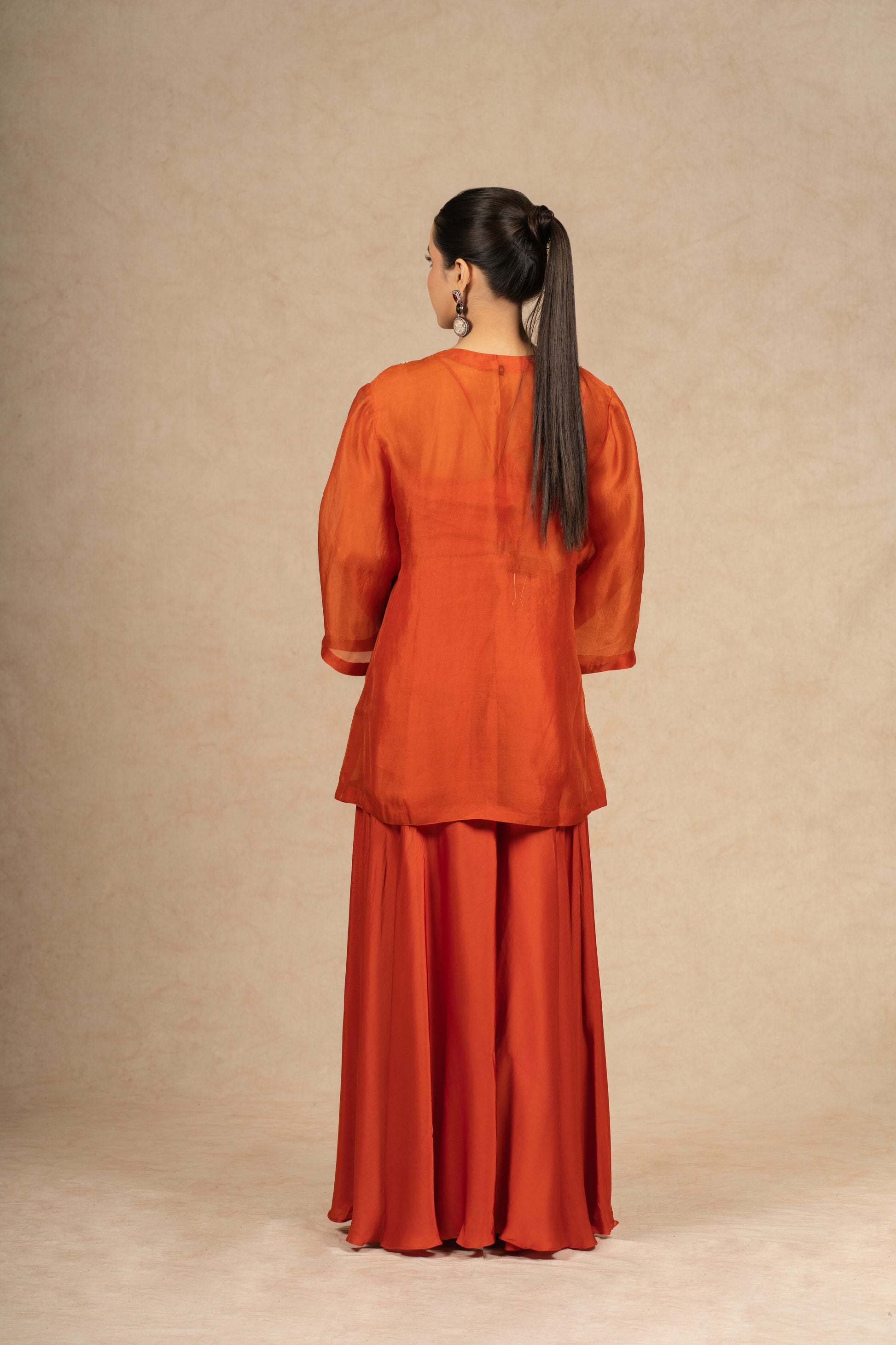 Back view of the Rust Organza Indo-Western outfit, highlighting the smooth drape and elegant finish of the fabric.