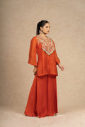 A stylish side view of the Rust Organza Indo-Western ensemble, featuring wide-leg pants and a relaxed fit top.