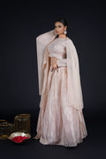 A regal look featuring a Tissue Rose Pink Lehenga, styled with an embellished choli and sheer dupatta, exuding traditional charm.