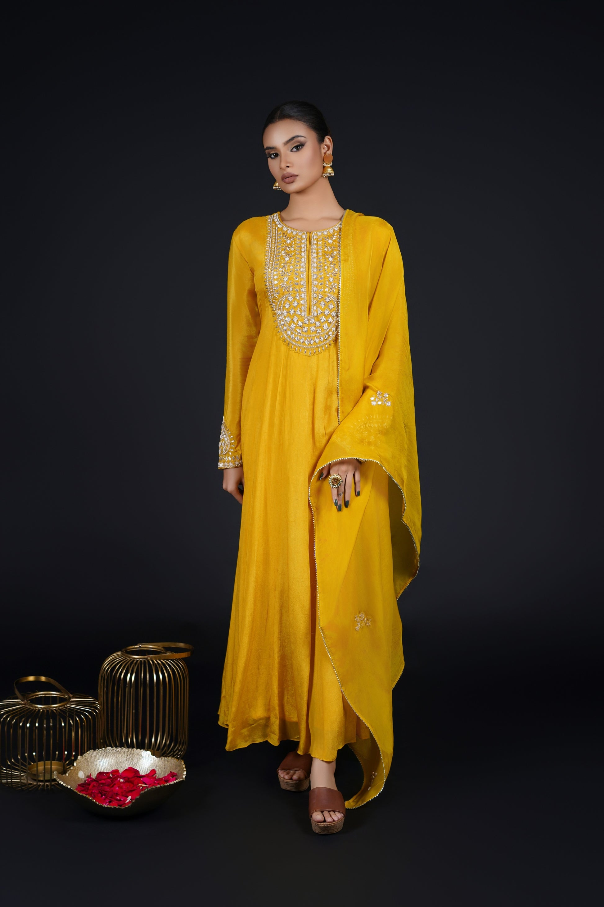 A timeless traditional outfit, yellow Kalidar Anarkali Suit with intricate detailing, paired with a sheer embroidered dupatta.